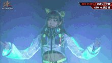 a girl with headphones on stands in front of a sign that says red stars