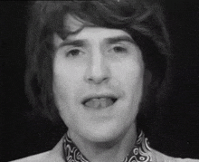 a close up of a man 's face with his tongue out .