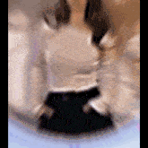 a blurry picture of a woman wearing a black skirt