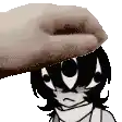 a hand is putting a cartoon character 's head on a table .