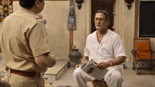 a man in a white shirt is talking to a police officer