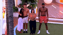 a group of people standing next to each other on a lawn