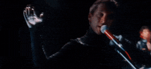 a blurry picture of a man 's face is being projected on a dark background .