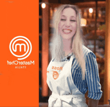 a woman wearing an apron with the letter m on it is smiling