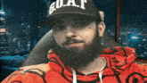 a man with a beard is wearing a hat that says goat on it