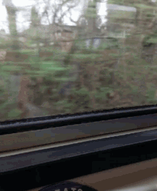 a blurry picture of a window with a sticker that says " a to " on it