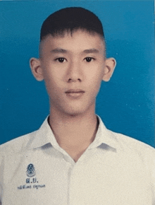 a young man in a white shirt with g.u. written on the collar
