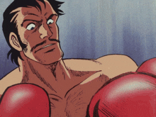 a man wearing red boxing gloves is looking at the camera