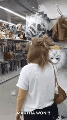 a woman wearing a lion mask is walking in a store .