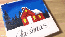 a painting of a red barn and the word christmas