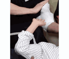 a person is holding a piece of paper over a person 's arm .