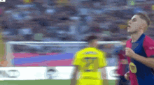 a soccer player wearing a yellow jersey with the number 7 on it is running on the field .