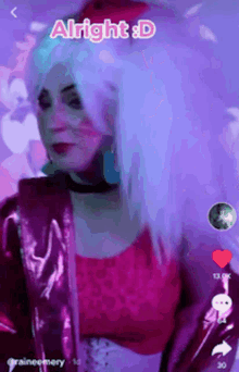 a woman with white hair and a pink jacket says alright