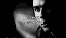 a black and white photo of a man 's face with the name damon salvatore written above him .