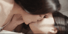 two women kissing each other on a bed