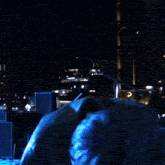 a young man with blue hair is holding a guitar in his hand .