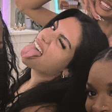 a woman sticking her tongue out and smiling