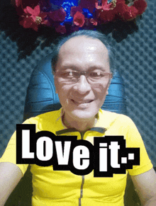 a man wearing glasses and a yellow shirt with the words love it on it