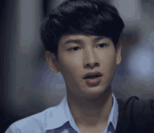 a close up of a young man 's face with a blurred background