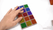 a person is playing with magnetic balls made by magneticman