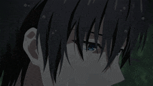 a close up of a person 's face with a tear coming out of their eye