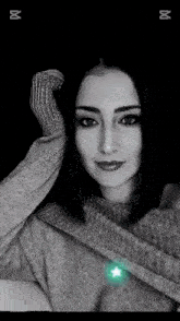 a black and white photo of a woman in a sweater