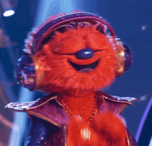 a stuffed animal wearing headphones and a necklace