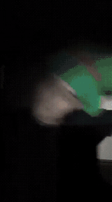 a blurry picture of a person with a green hat