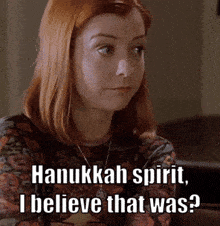 a woman with red hair is wearing a shirt that says hanukkah spirit , i believe that was ?
