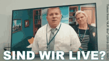 a man and a woman are standing in front of a screen that says sind wir live ?