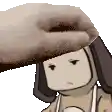 a person is petting a cartoon character 's head with a hand .
