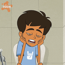 a cartoon of a boy sitting on a toilet with a nickelodeon logo in the corner