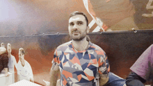 a man with a beard wearing a shirt that says adidas on it