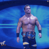 a shirtless wrestler is standing in front of a blue background with the letters wf on it