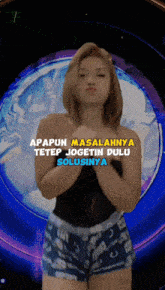 a woman in shorts stands in front of a blue background with the words apapun masalahnya tetep jogetin dulu