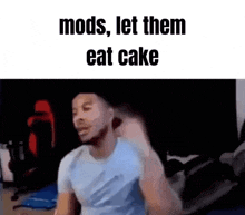 a man is sitting in a room with the words `` mods , let them eat cake '' written above him .