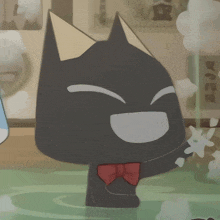 a cartoon cat with a red bow tie is smiling