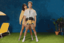 a man and a woman standing next to each other on a grassy field