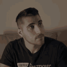 a man is wearing a black shirt that says squier on it