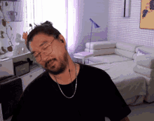a man with a beard wearing glasses and headphones