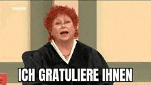 a woman in a judge 's robe is sitting in a courtroom and saying ich gratuliere ihnen .