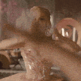 a woman in a pink dress is holding a crown in her hand
