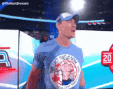 a man wearing a blue shirt that says " the last time is now "