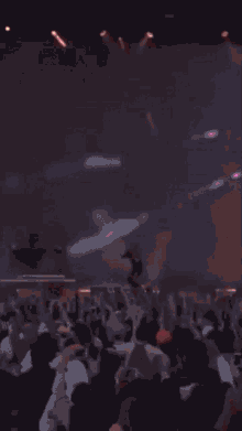 a man stands on a stage in front of a large red screen