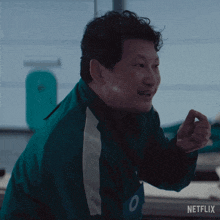 a man in a green jacket says " are you good with numbers " in white letters