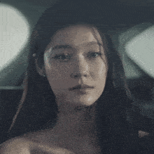 a close up of a woman 's face with a tear running down her cheek