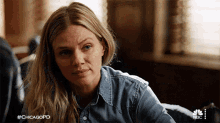 a woman in a denim shirt with #chicagopd written on the bottom right