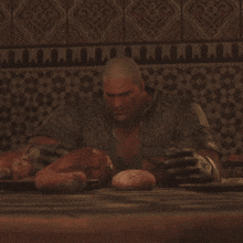 a man is laying on a table holding a large ball