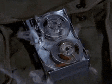 a close up of a tape recorder with smoke coming out of it on a table .