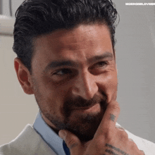 a close up of a man 's face with the word morronellovebra visible